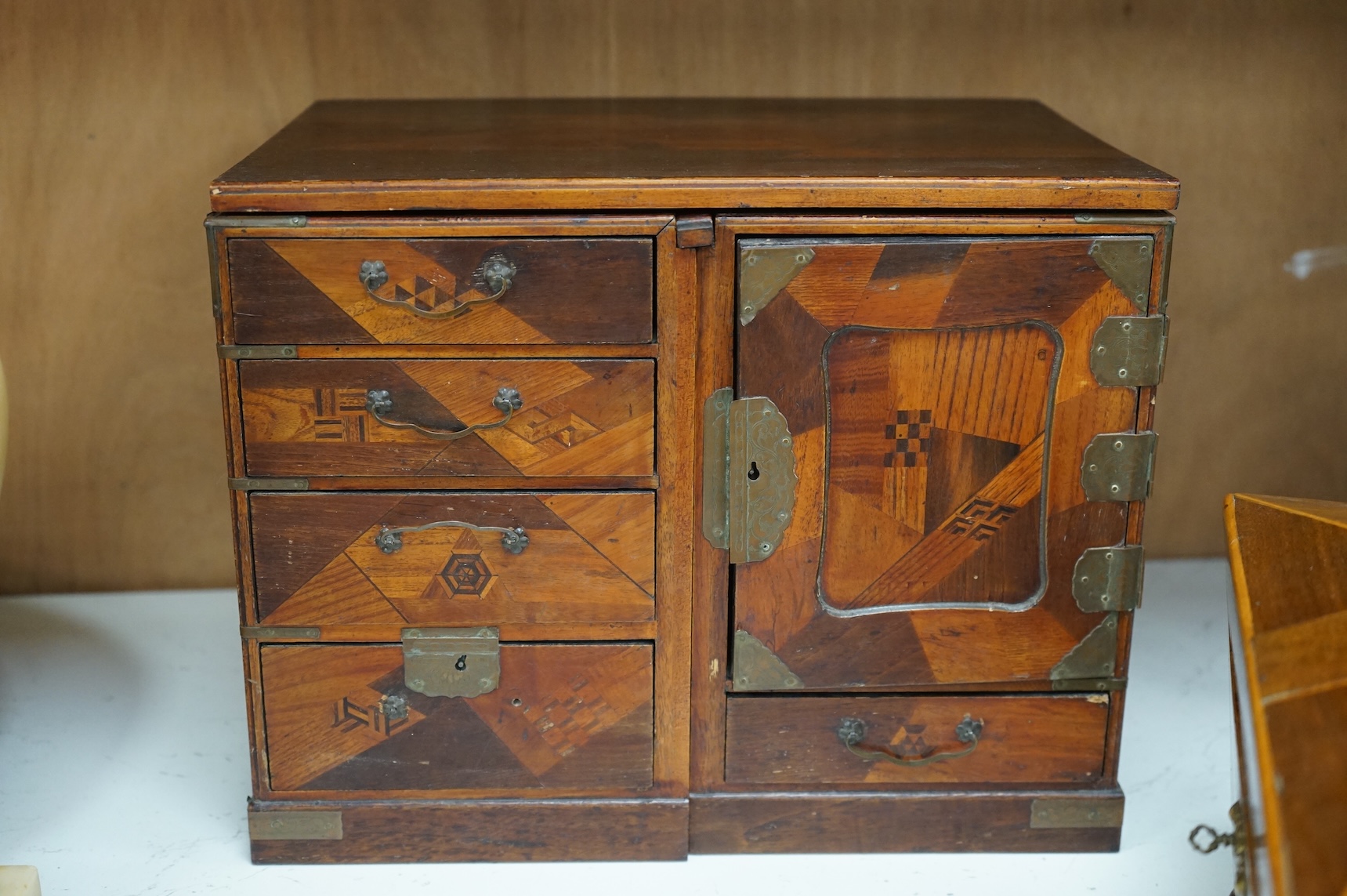A Japanese parquetry table-top cabinet and a 19th century tea caddy, cabinet 33cm wide, 26cm high.
